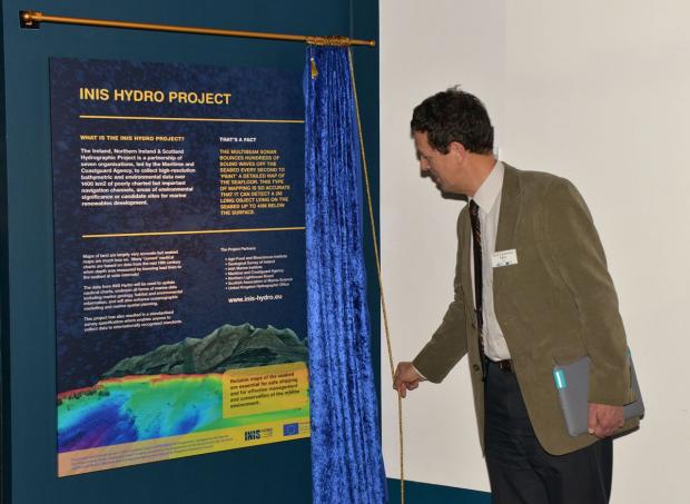 Professor Laurence Mee (Scottish Association of Marine Sciences) unveiling the permanent display board in the Titanic Builiding.