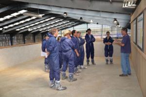 Mike Davies giving the group an overview of herd management practices in the parlour