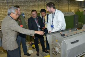 Mr Talavera and Mr Rambuyan are shown how the screw press is operated by Professor Sharma and Eugene Carmichael (AFBI).